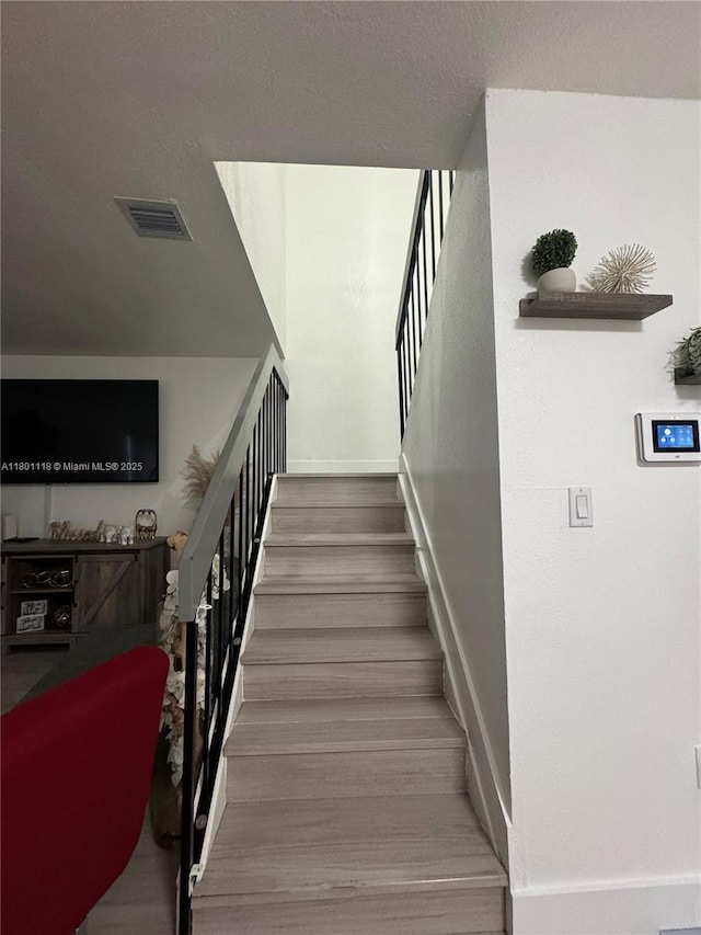 8098 NW 99th Ter, Hialeah Gardens, FL 33016 - stairs featuring baseboards and wood finished floors
