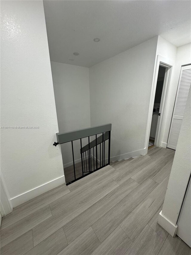 8098 NW 99th Ter, Hialeah Gardens, FL 33016 - hallway featuring baseboards and wood finished floors
