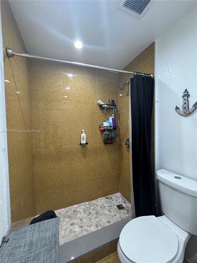 8098 NW 99th Ter, Hialeah Gardens, FL 33016 - bathroom with toilet and tiled shower