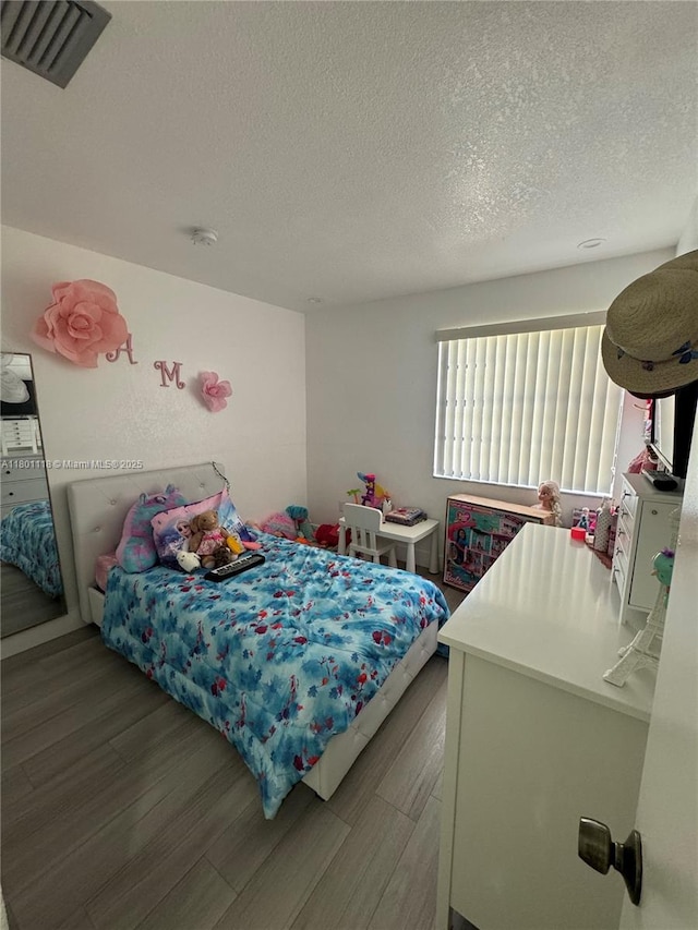 8098 NW 99th Ter, Hialeah Gardens, FL 33016 - bedroom featuring wood finished floors and a textured ceiling