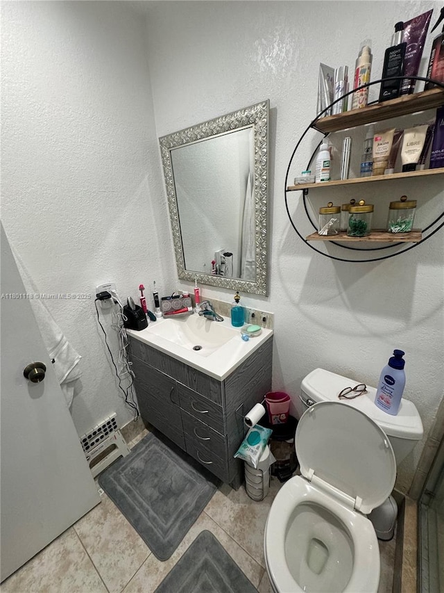 8098 NW 99th Ter, Hialeah Gardens, FL 33016 - bathroom with a textured wall, toilet, vanity, and tile patterned flooring