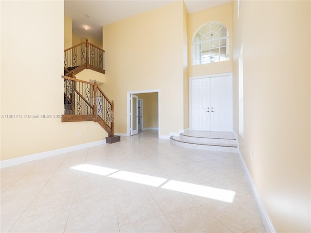 5087 SW 183rd Ave, Miramar, FL 33029 - entryway with a high ceiling, stairs, tile patterned flooring, and baseboards