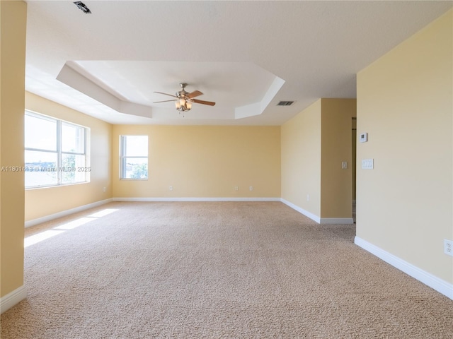 5087 SW 183rd Ave, Miramar, FL 33029 - empty room featuring a tray ceiling, ceiling fan, light colored carpet, and baseboards