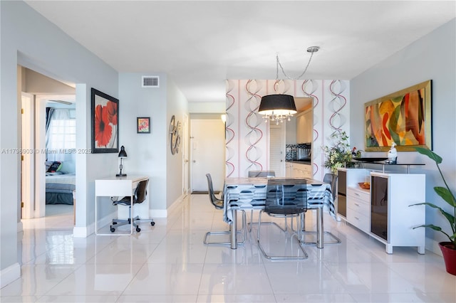 16900 NE 14th Ave Unit 201, North Miami Beach, FL 33162 - dining space with a chandelier and baseboards