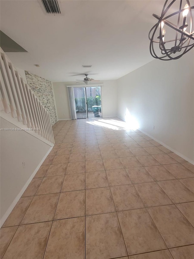 7818 Catalina Cir, Tamarac, FL 33321 - empty room featuring light tile patterned flooring, a ceiling fan, a chandelier, and baseboards