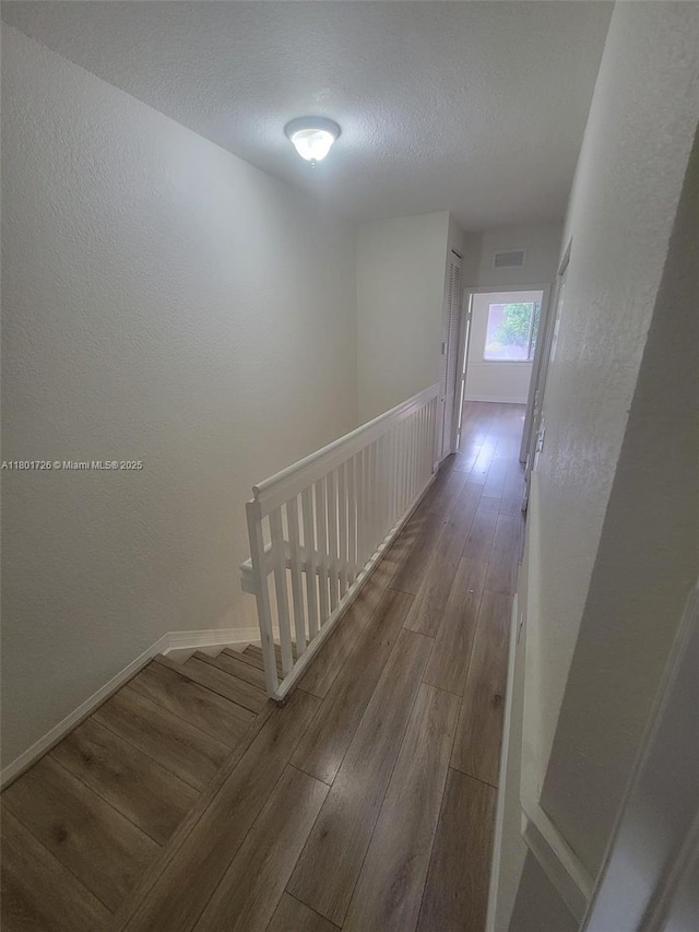7818 Catalina Cir, Tamarac, FL 33321 - hallway with wood finished floors, baseboards, a textured ceiling, and a textured wall