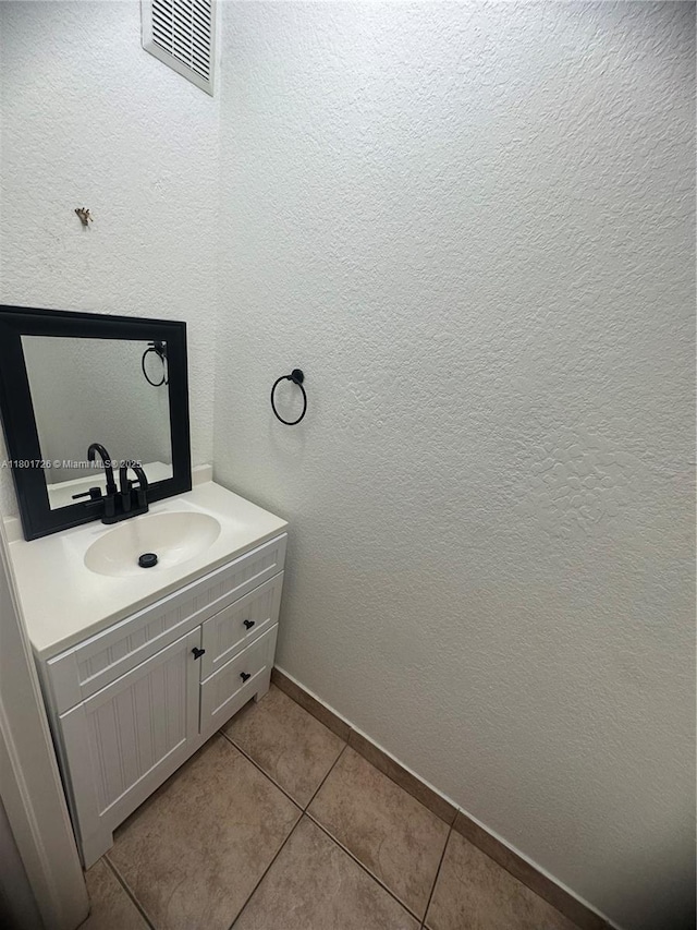 7818 Catalina Cir, Tamarac, FL 33321 - bathroom featuring tile patterned flooring, baseboards, vanity, and a textured wall