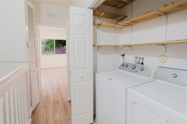 7818 Catalina Cir, Tamarac, FL 33321 - laundry area featuring washing machine and dryer and light wood-style flooring