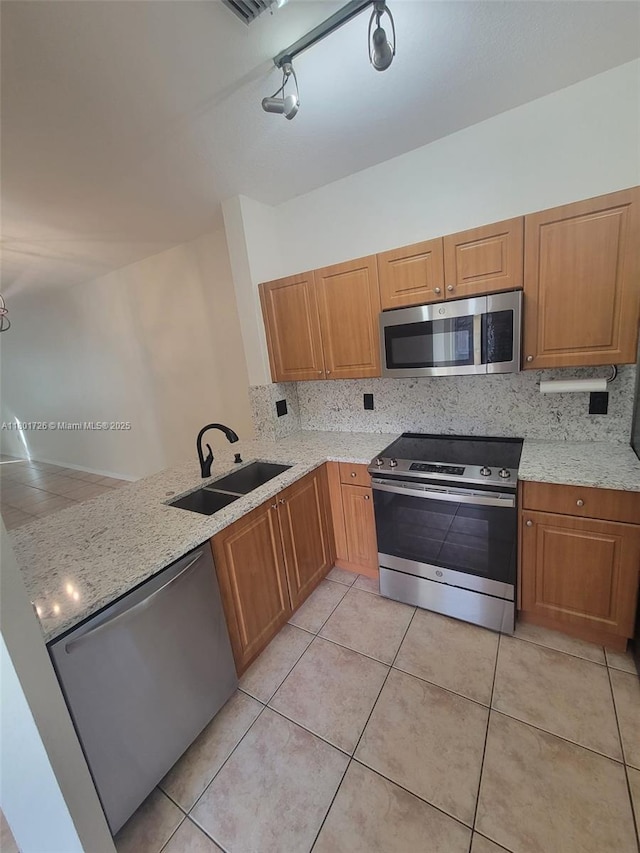 7818 Catalina Cir, Tamarac, FL 33321 - kitchen with appliances with stainless steel finishes, a sink, backsplash, and light tile patterned floors