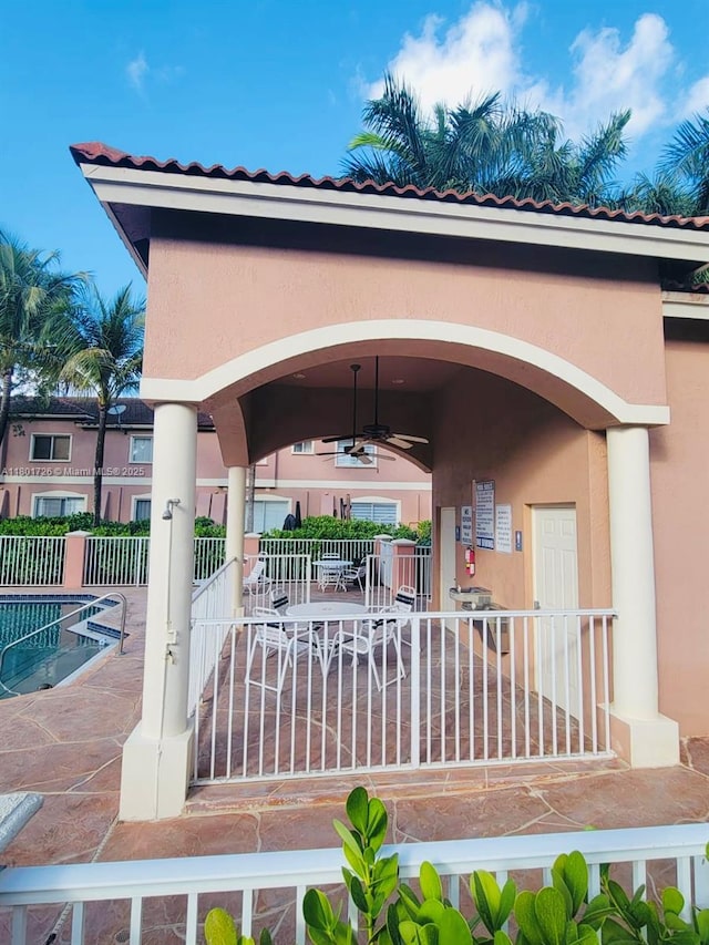 7818 Catalina Cir, Tamarac, FL 33321 - view of patio with a ceiling fan, fence, and a community pool