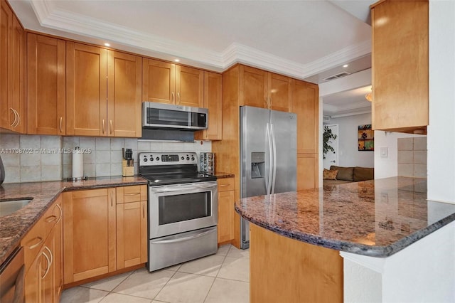137 Golden Isles Dr Unit 1105, Hallandale Beach, FL 33009 - kitchen with appliances with stainless steel finishes, ornamental molding, backsplash, dark stone counters, and recessed lighting