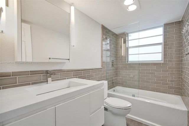 137 Golden Isles Dr Unit 1105, Hallandale Beach, FL 33009 - bathroom with tile walls, toilet, shower / bathtub combination, and vanity