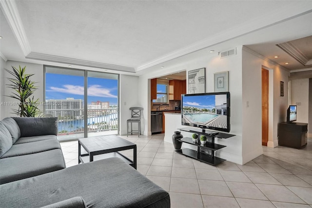 137 Golden Isles Dr Unit 1105, Hallandale Beach, FL 33009 - living area with a raised ceiling, light tile patterned floors, ornamental molding, baseboards, and a wall of windows