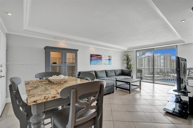 137 Golden Isles Dr Unit 1105, Hallandale Beach, FL 33009 - dining space with a raised ceiling, light tile patterned flooring, floor to ceiling windows, crown molding, and recessed lighting