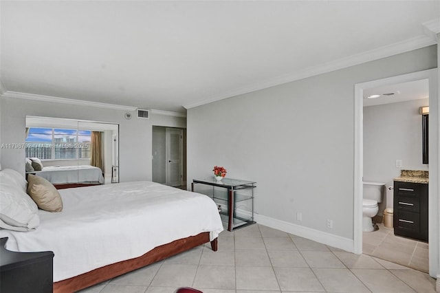 137 Golden Isles Dr Unit 1105, Hallandale Beach, FL 33009 - bedroom with ornamental molding, light tile patterned floors, baseboards, and connected bathroom