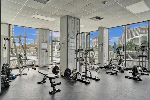 137 Golden Isles Dr Unit 1105, Hallandale Beach, FL 33009 - gym featuring a wall of windows, a view of city, and a drop ceiling
