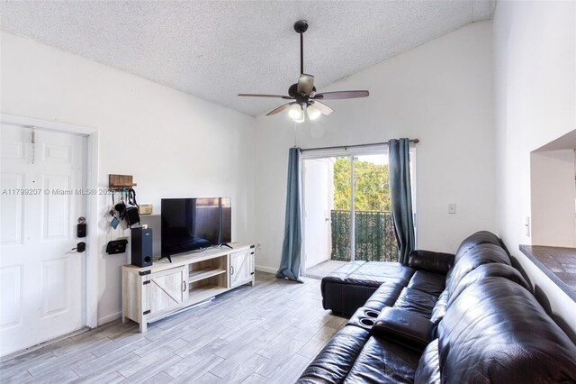 2301 NW 96th Ter Unit 16C, Pembroke Pines, FL 33024 - living room with ceiling fan, a textured ceiling, light wood-type flooring, vaulted ceiling, and baseboards
