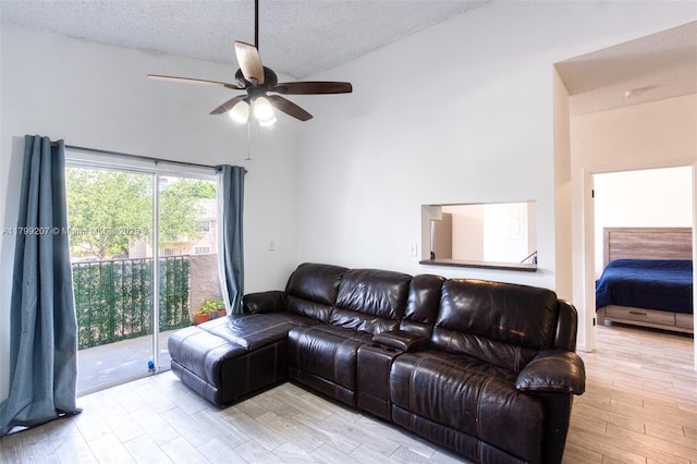 2301 NW 96th Ter Unit 16C, Pembroke Pines, FL 33024 - living area featuring a ceiling fan, light wood-type flooring, high vaulted ceiling, and a textured ceiling
