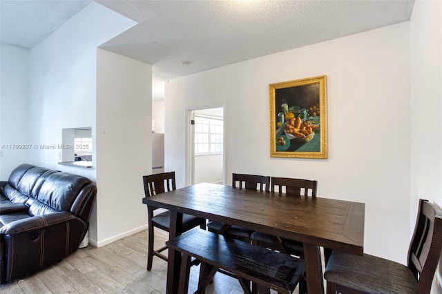 2301 NW 96th Ter Unit 16C, Pembroke Pines, FL 33024 - dining space featuring light wood finished floors and a textured ceiling