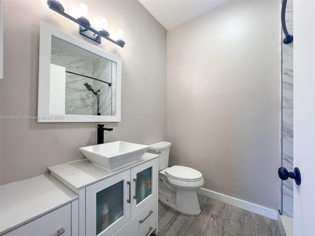 2301 NW 96th Ter Unit 16C, Pembroke Pines, FL 33024 - full bathroom with wood finished floors, toilet, a shower, vanity, and baseboards