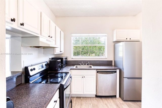 2301 NW 96th Ter Unit 16C, Pembroke Pines, FL 33024 - kitchen featuring stainless steel appliances, a sink, dark countertops, and white cabinets