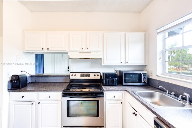 2301 NW 96th Ter Unit 16C, Pembroke Pines, FL 33024 - kitchen with appliances with stainless steel finishes, custom exhaust hood, a sink, and white cabinets