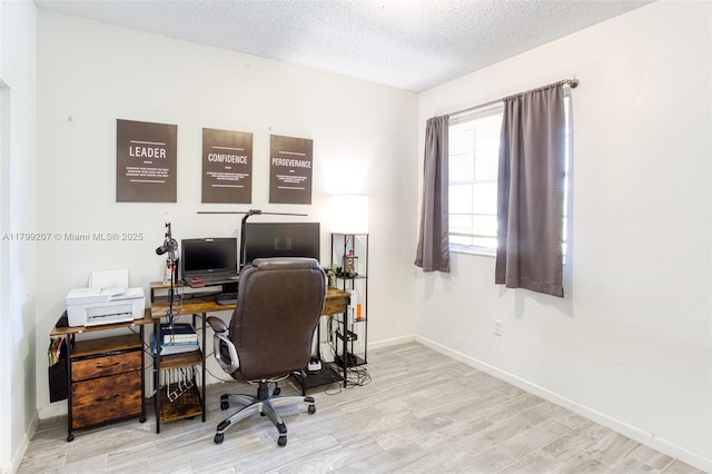 2301 NW 96th Ter Unit 16C, Pembroke Pines, FL 33024 - home office featuring wood finished floors, a textured ceiling, and baseboards