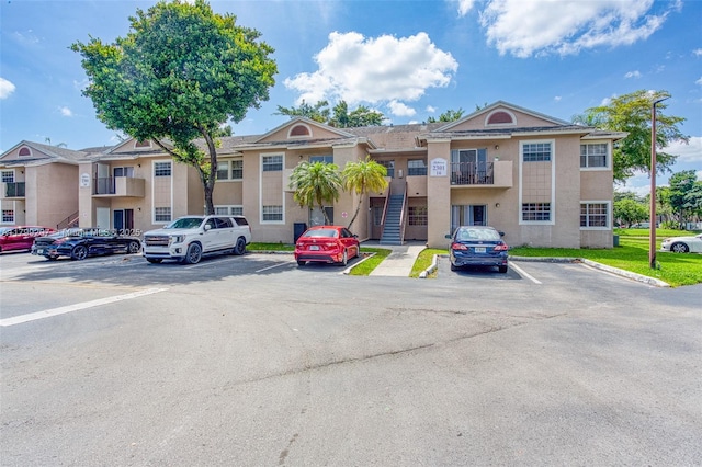 2301 NW 96th Ter Unit 16C, Pembroke Pines, FL 33024 - view of building exterior with uncovered parking