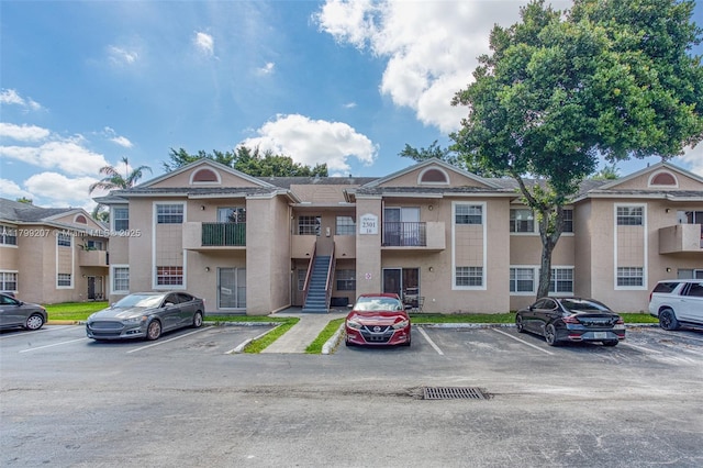 2301 NW 96th Ter Unit 16C, Pembroke Pines, FL 33024 - view of building exterior featuring uncovered parking