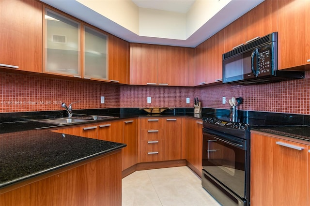 16699 Collins Ave Unit 3401, Sunny Isles Beach, FL 33160 - kitchen featuring black appliances, a sink, brown cabinets, dark stone countertops, and decorative backsplash