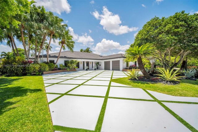 4430 Casper Ct, Hollywood, FL 33021 - view of front facade with an attached garage, concrete driveway, and a front yard