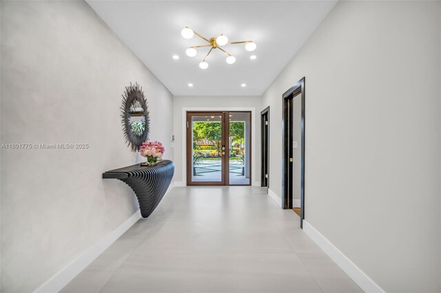 4430 Casper Ct, Hollywood, FL 33021 - hallway featuring a chandelier, baseboards, french doors, and finished concrete floors