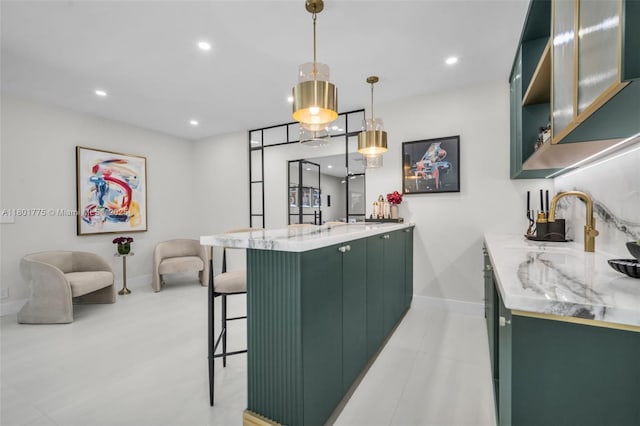 4430 Casper Ct, Hollywood, FL 33021 - kitchen featuring green cabinetry, a peninsula, a breakfast bar, baseboards, and recessed lighting