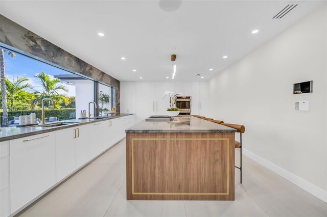 4430 Casper Ct, Hollywood, FL 33021 - kitchen featuring modern cabinets, white cabinets, appliances with stainless steel finishes, recessed lighting, and a kitchen island
