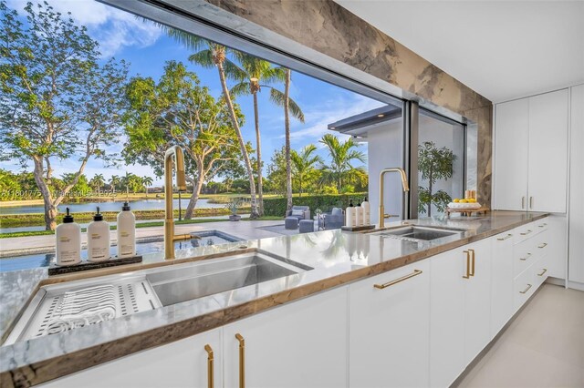 4430 Casper Ct, Hollywood, FL 33021 - kitchen with a sink, a water view, and white cabinetry