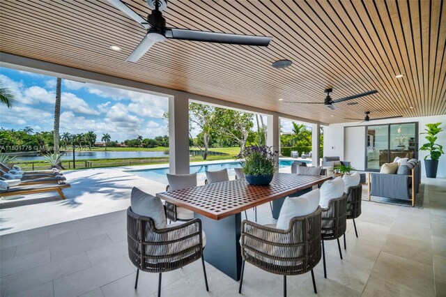 4430 Casper Ct, Hollywood, FL 33021 - view of patio featuring ceiling fan, a water view, an outdoor pool, and exterior bar