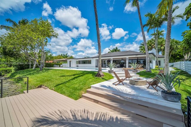 4430 Casper Ct, Hollywood, FL 33021 - deck featuring an outdoor fire pit, a swimming pool, a yard, and a patio area