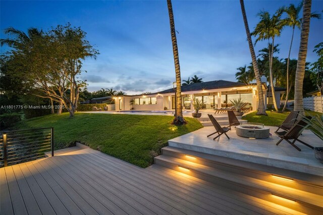 4430 Casper Ct, Hollywood, FL 33021 - wooden terrace featuring an outdoor fire pit, a lawn, and a patio area
