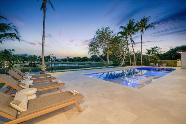 4430 Casper Ct, Hollywood, FL 33021 - pool at dusk featuring a patio area, a hot tub, an outdoor pool, and a water view