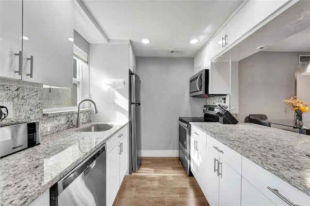 8504 Old Country Mnr Unit 205, Davie, FL 33328 - kitchen with stainless steel appliances, a sink, light stone counters, tasteful backsplash, and recessed lighting