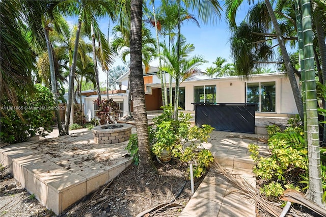 2548 Tortugas Ln, Fort Lauderdale, FL 33312 - view of front facade featuring a fire pit, a patio area, and stucco siding