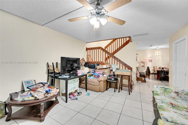 1458 N Lawnwood Cir Unit 24, Fort Pierce, FL 34950 - living room featuring stairway, tile patterned flooring, ceiling fan, a textured ceiling, and a chandelier