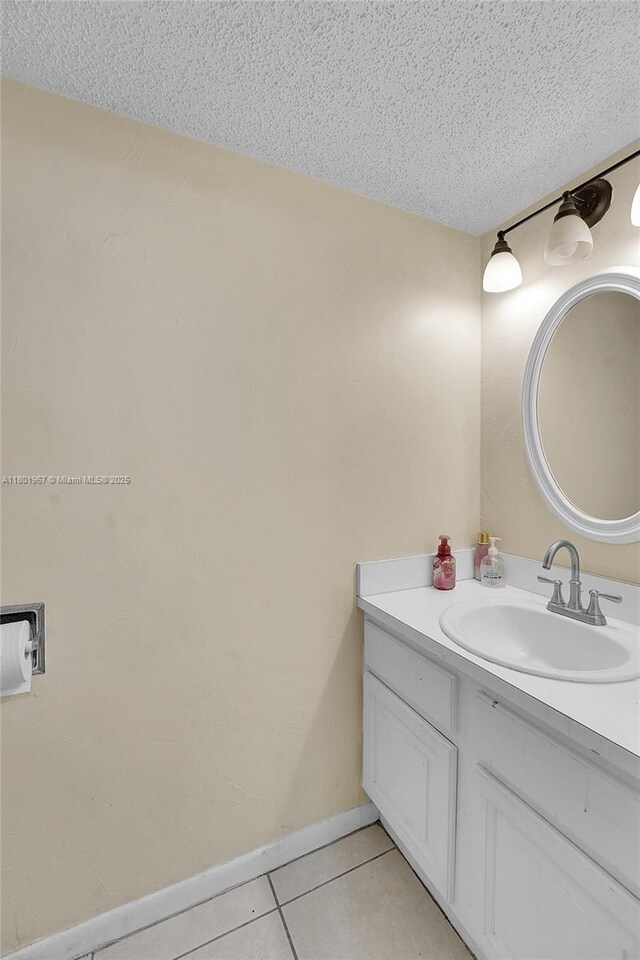 1458 N Lawnwood Cir Unit 24, Fort Pierce, FL 34950 - bathroom featuring tile patterned floors, a textured ceiling, and vanity