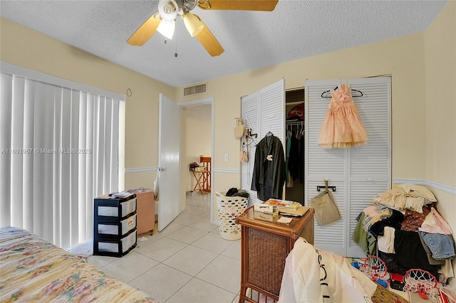 1458 N Lawnwood Cir Unit 24, Fort Pierce, FL 34950 - bedroom with light tile patterned floors, a textured ceiling, ceiling fan, and a closet