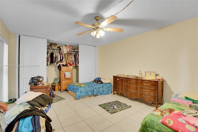 1458 N Lawnwood Cir Unit 24, Fort Pierce, FL 34950 - bedroom featuring a closet, light tile patterned floors, ceiling fan, and a textured ceiling