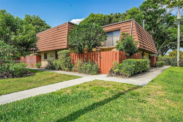1458 N Lawnwood Cir Unit 24, Fort Pierce, FL 34950 - view of front of property featuring mansard roof and brick siding