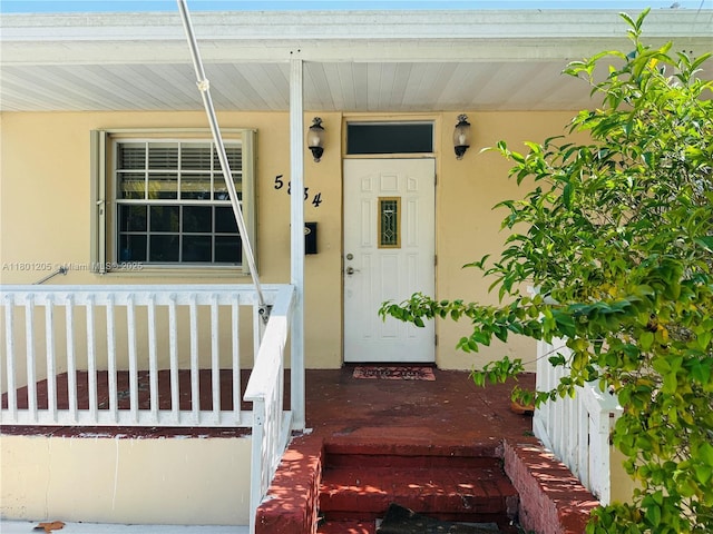 5834 SW 66th St, South Miami, FL 33143 - property entrance featuring a porch and stucco siding