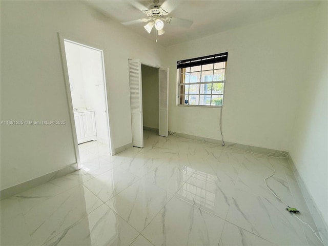 5834 SW 66th St, South Miami, FL 33143 - unfurnished bedroom featuring baseboards, light marble finish flooring, a ceiling fan, and a closet