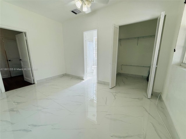 5834 SW 66th St, South Miami, FL 33143 - unfurnished bedroom featuring marble finish flooring, baseboards, a closet, and a walk in closet