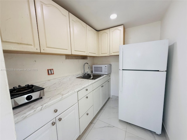 5834 SW 66th St, South Miami, FL 33143 - kitchen with white appliances, a sink, light marble finish flooring, recessed lighting, and light stone counters